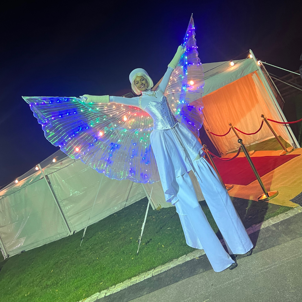 Stilt walker with wings ready to greet guests to Deckerdence unique venue